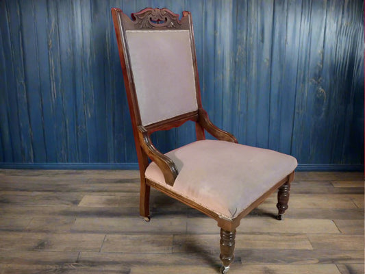 Carved oak antique upholstered nursing chair on castors